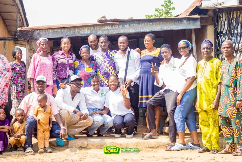 Love & Light Foundation volunteers gathered with members of a local community, including elders and children
